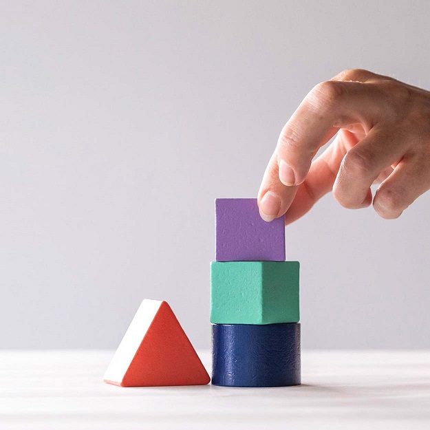 Hand stacking wooden blocks 