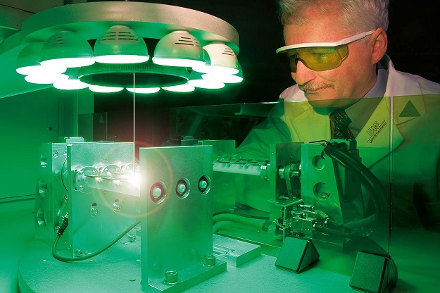 Cientist from LPKF looking to a laser manufactured by lPKF